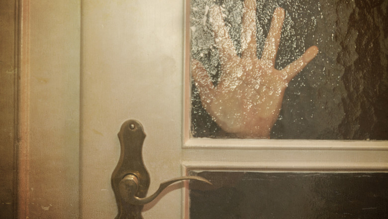 Silhouette of Hand Coming opening the door slowly