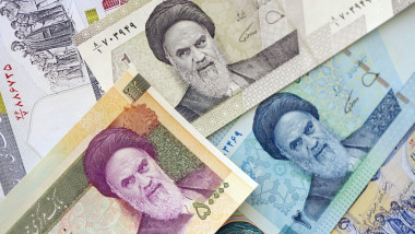 Iranian rial money bills pile on table. Iran banknotes of IRR currency close up. Concept of business, economy and banking in Iran