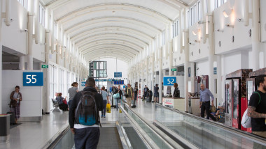 Sydney, Kingsford Smith airport, internal shot of the domestic airport terminal, passengers on travellator moving staircase, NSW, Australia