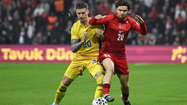 Romania's forward #20 Dennis Man fights for the ball with Turkey's defender #20 Ferdi Kadioglu during the play-off FIFA World Cup 2026 European qualification knockout semi-final football match between Turkey and Romania at Besiktas Park stadium