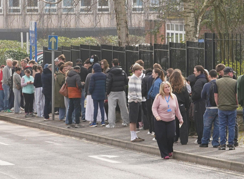 People wait in line outside a meningitis vaccination hub at the Vicarage Lane Clinic in Ashford, Kent. The vaccine programme in Kent is being rolled out to anyone who attended Club Chemistry from March 5 to March 15, year 12 and 13 pupils at schools with