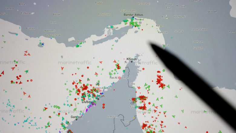 Paris, France - March 16, 2026: A pen indicates the Strait of Hormuz on a Marine Traffic map, symbolizing maritime analysis and strategic planning
