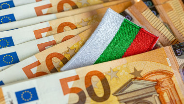 Admission of Bulgaria to the euro zone in 2026. The flag of Bulgaria sticking out from between the Euro banknotes. Financial concept.