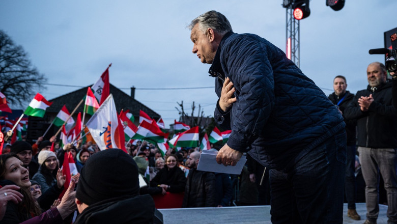 Hungarian PM VIKTOR ORBAN takes a bow as his supporters cheer for him ar poitical rally
