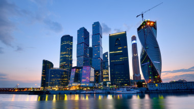 View of skyscrapers on Moskva river at night, Moscow, Russia