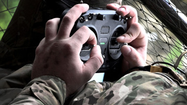 Serviceman operates a drone. War in Ukraine. Operator controls the drone.