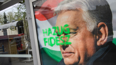A tag reads 'Liar Fidesz' over a placard about a national petition against war, showing outgoing Hungarian Prime Minister and Fidesz leader Viktor Orban, at a bus stop near the South Railway Station in Budapest