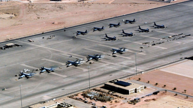 Aerial view of the North Ramp at Prince Sultan Air Base, Saudi Arabia, during Operation SOUTHERN WATCH. Aircraft visable on the flight line (Left to right) are Saudi Air Force 707's, US Air Force E-3 AWACS Sentrys and KC-135 Stratotankers. Personal workin