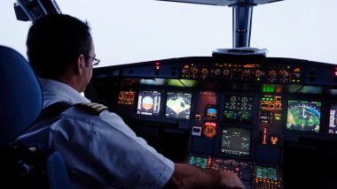 A pilot in the cockpit of an Airbus A320 aircraft of the Aegean Airlines