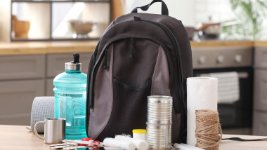 Emergency backpack with necessities on table in kitchen