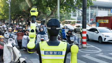 HANGZHOU, CHINA - MAY 01: A robot traffic officer directs traffic on the street on the first day of the May Day holiday