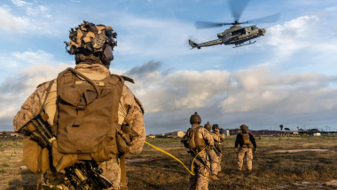 U.S. Marines with 3rd Battalion, 1st Marines, 1st Marine Division, steady a SKED device as it is airlifted onto a UH-1Y Venom attached to Marine Light