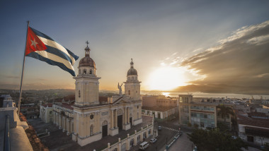 Cuban flag over Plaza de la Catedral at sunset, Santiago de Cuba, Cuba