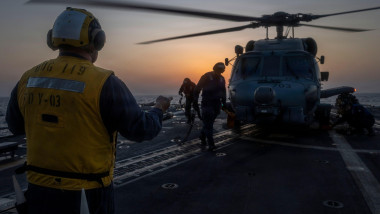 A U.S. Sailor assigned to Arleigh Burke-class guided-missile destroyer USS Delbert D. Black (DDG 119) directs an MH-60R Sea Hawk helicopter, attached to Helicopter Maritime Strike Squadron (HSM) 46, during a flight quarter evolution in the U.S. Central Co