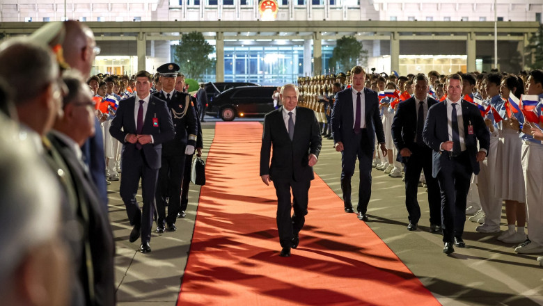 Vladimir Putin walks at Beijing Capital Airport as he departs Beijing on May 20, 2026