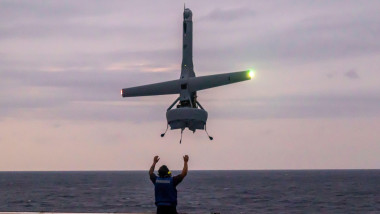 A civilian contractor embarked with the 31st Marine Expeditionary Unit, lands a V-BAT drone aboard the amphibious transport dock ship USS Green Bay (LPD-20) in the Philippine Sea, Feb. 2, 2023. The V-BAT is an autonomous drone used for surveillance and re