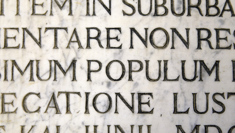 Latin script engraving on marble as seen on a wall in Venice, Italy