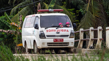 North Aceh, Indonesia. 21st Dec, 2025. A broken-down ambulance sits on a rural bridge in Langkahan Subdistrict. The medical unit suffered mechanical failure due to the massive flash floods that struck Aceh, North Sumatra, and West Sumatra in November 2025