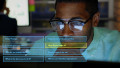 Using computer, man interacting with artificial intelligence interface for assistance