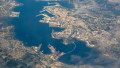 View through plane window, oblique aerial view of port city of Ferrol, Galicia, Spain