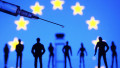 Ukraine. 27th Dec, 2020. In this photo illustration a medical syringe and small toy figures of people are seen in front of the EU flag. The European Union start COVID-19 coronavirus vaccination from 27 December 2020, reportedly by media. Credit: SOPA Imag