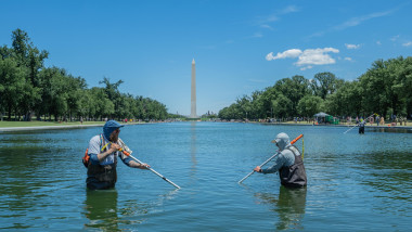 Workers Remove Algae From Reflecting Pool