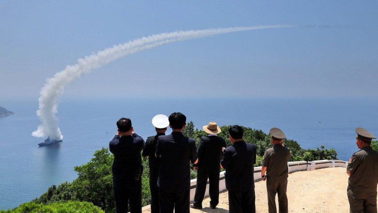 Kim Jong Un (C) observing performance tests of the main weapons systems of the destroyer Kang Kon at an undisclosed location in North Korea