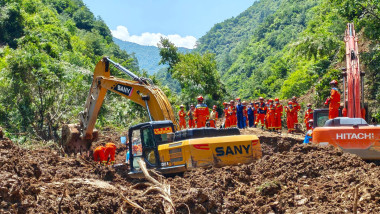 Rescuers work at the site of a landslide that took place at a village in Nanhe township of Tanchang County, Longnan City, northwest China's