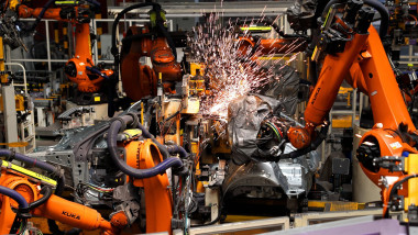 QINGDAO, CHINA - AUGUST 18: Robotic arms work on the assembly line of vehicles at a workshop of FAW-Volkswagen on August