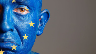 Man with his face painted with the flag of European Union. The man is sad and photographic composition leaves only half of the f