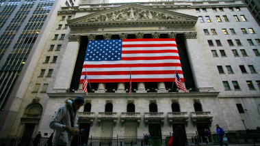 Facade of the New York Stock Exchange in New York city in Wall Street decorated with a US flag