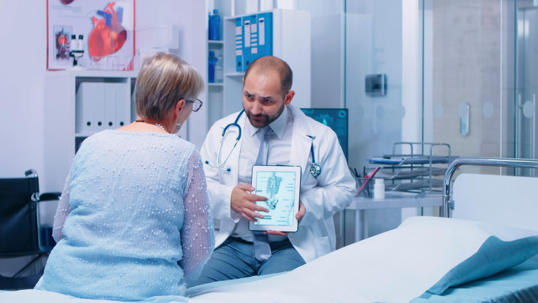 Doctor explains marble bone disease to patient with patient communication, diagnosis discussion and professional healthcare support inside a modern private clinic.