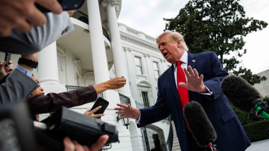 United States President Donald Trump speaks to members of the press before departing from the new South Lawn helipad