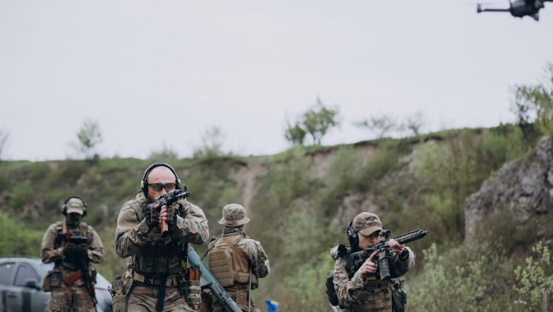Group of Ukrainian military using a drone to detect enemy positions