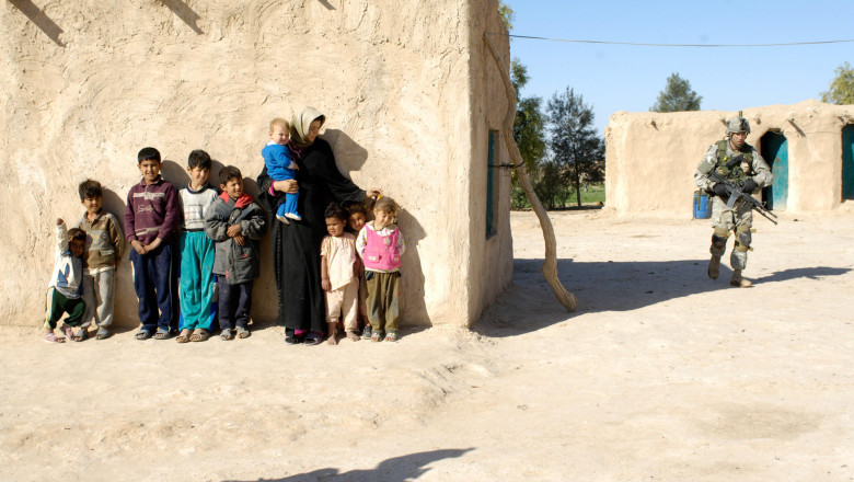 U.S. Army personnel conduct house searches in Salah Ad Din Province during Operation Swarmer, a large-scale air assault with over 50 helicopters and 1,500 U.S. and Iraqi military personnel.