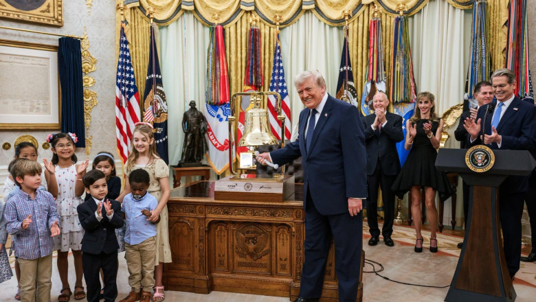 US President Donald Trump with children in the Oval Office of The White House as he rings the opening bell for the stock market and announces his childhood savings plan - Trump Accounts.