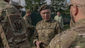 Commander-in-Chief of the Armed Forces of Ukraine Mykhailo Drapaty (C) speaks with Ukrainian servicemen