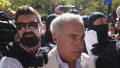 Calin Georgescu, insotit de ofiteri de politie la sediul DIICOT pentru audiere, in Bucuresti, 21 septembrie 2026.