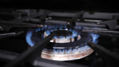 An over hob gas ring burning with a blue flame. Natural resources and energy use concept.