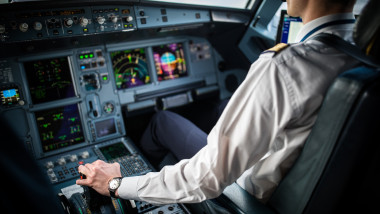 Pilot's hand accelerating on the throttle in a commercial airliner airplane flight cockpit during takeoff