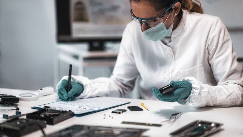 Forensics. Police Expert Examining Confiscated Mobile phone