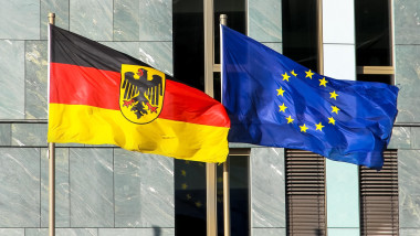 Flags of Germany (Federal Republic of Germany; in German: Bundesrepublik Deutschland) and the European Union (EU) waving in the wind.