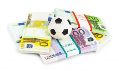Money and soccer ball Money and soccer ball isolated on white background Copyright: xIMAGO/Zoonar.com/NikolaixSorokinx 1