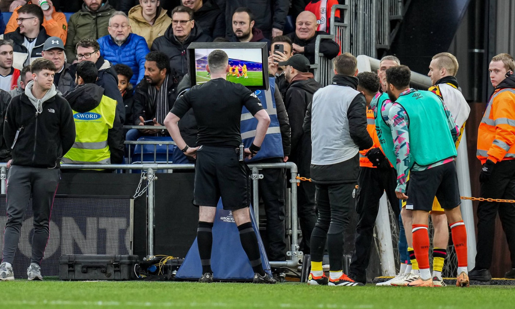 Referee, Mr Chris Kavanagh, checks the VAR screen before awarding Luton Town a penalty during the Premier League match b
