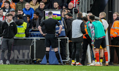 Referee, Mr Chris Kavanagh, checks the VAR screen before awarding Luton Town a penalty during the Premier League match b