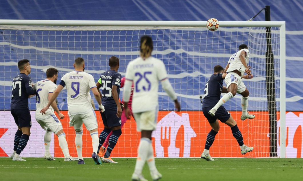 Madrid, Spain, 4th May 2022. Rodrygo of Real Madrid anticipates Ruben Dias of Manchester City to head the ball past Ederson in the Manchester City goal and give the side a 2-1 lead and level the aggregate scores at 5-5 to take the tie into extra time duri