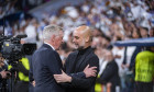 Carlo Ancelotti (L), coach of Real Madrid, hugs Josep Pep Guardiola (R), head coach of Manchester City, before the UEFA