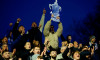 A fan in the stands holds up a replica of the FA Cup trophy at the end of the Emirates FA Cup Third Round match at Rodney Parade, Newport. Picture date: Saturday January 6, 2024.