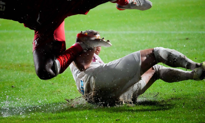 Romania Liga I: UTA Arad v CFR Cluj Yacoub Aly Abeid and Cristi Manea fight for the ball throughout the heavy rain durin