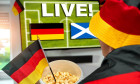 Germany - June 13, 2024: Symbolic image EURO 2024 opening match between Germany and Scotland. A soccer fan sits in front